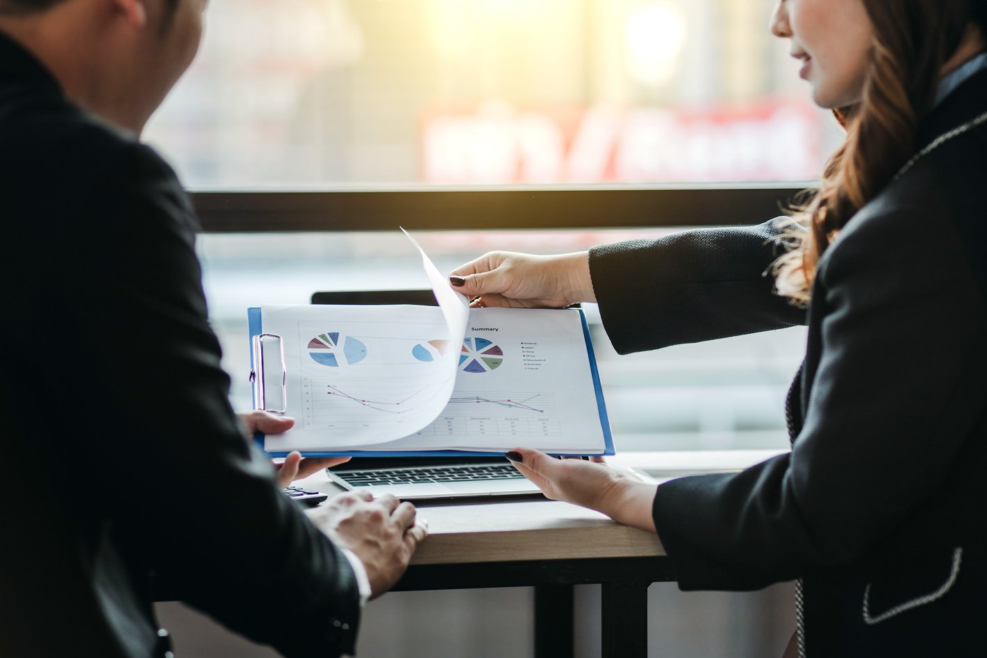 Businessman and Businesswoman Sitting to Discuss Financial Inves
